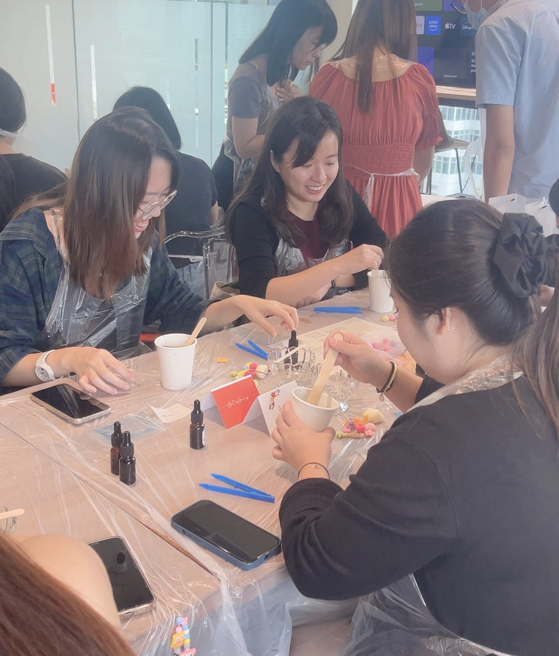 A team enjoying a hands-on creative candle workshop