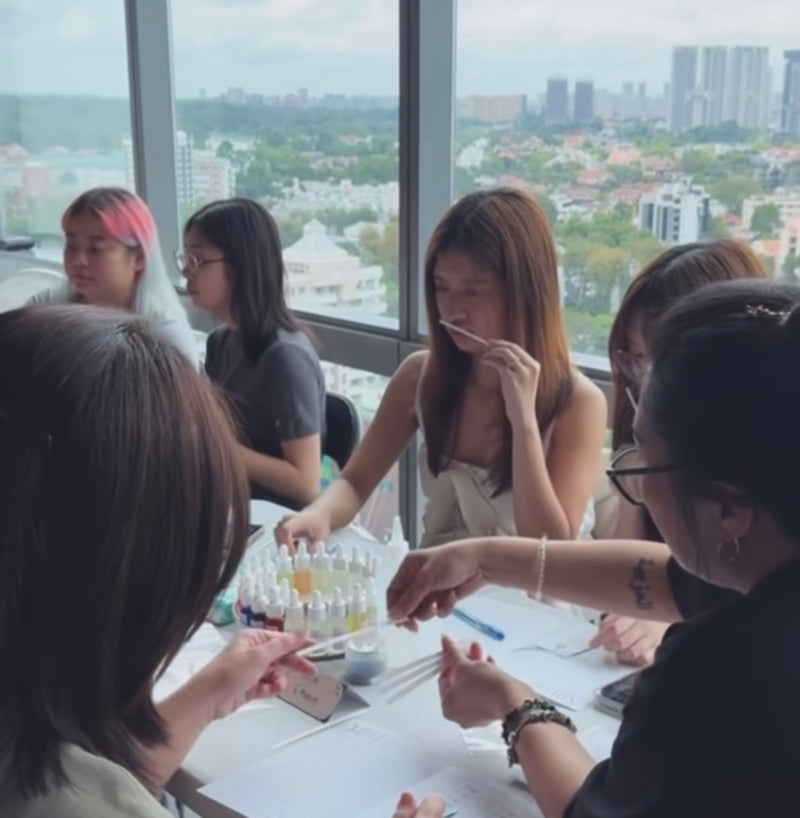 A team exploring fragrance notes during a perfume-making workshop