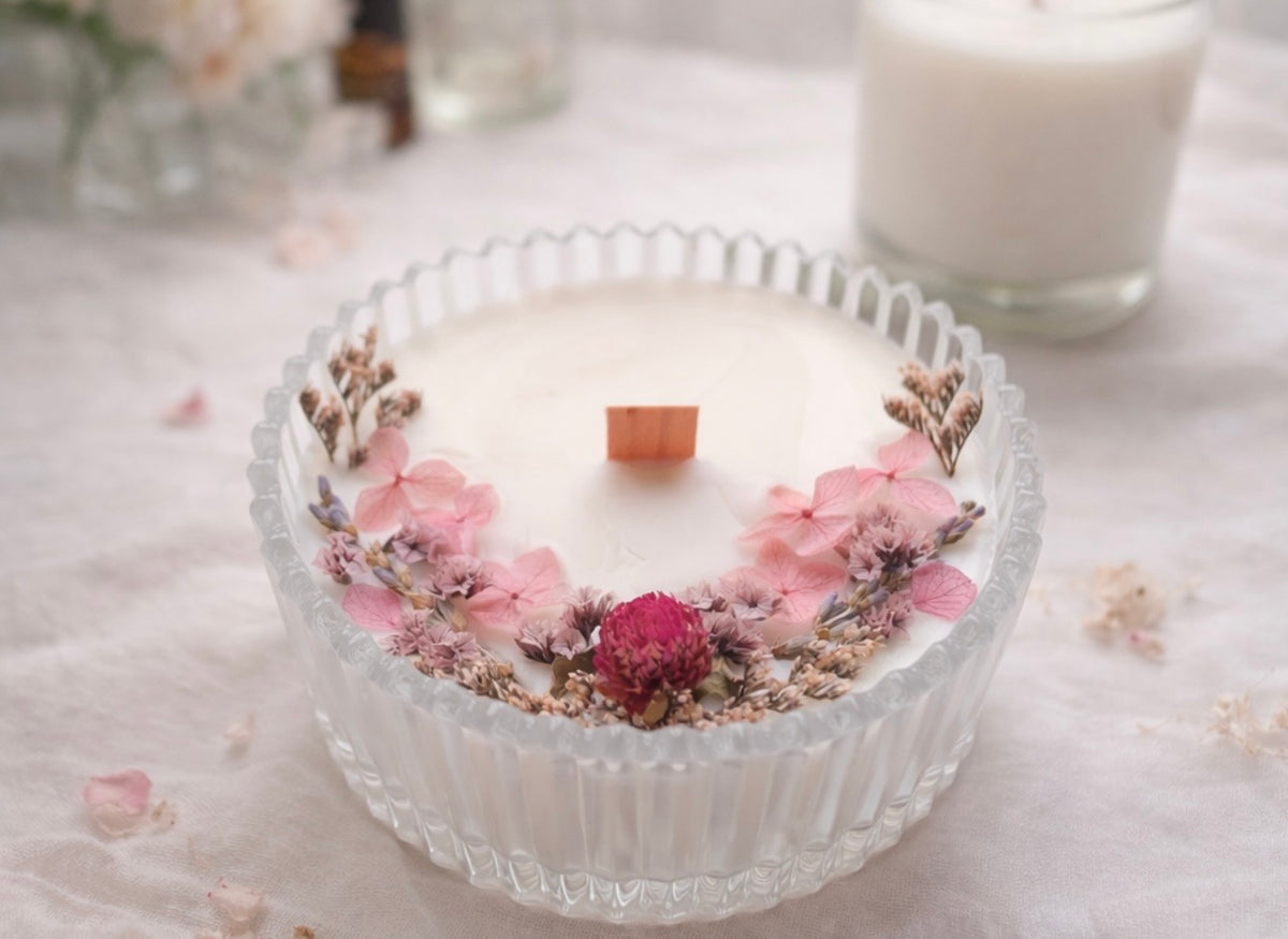 Dried-flower candle in a clear glass container