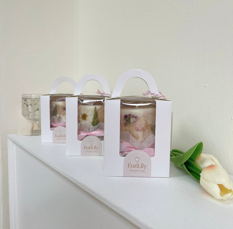 Floral scented candles finished with personalised packaging and pink ribbons